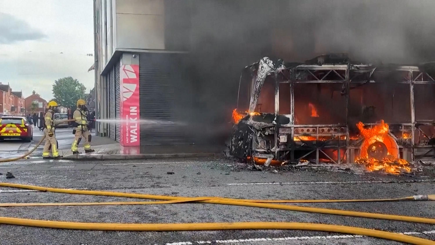 Protesters set fire to bus as unrest continues after knife attack